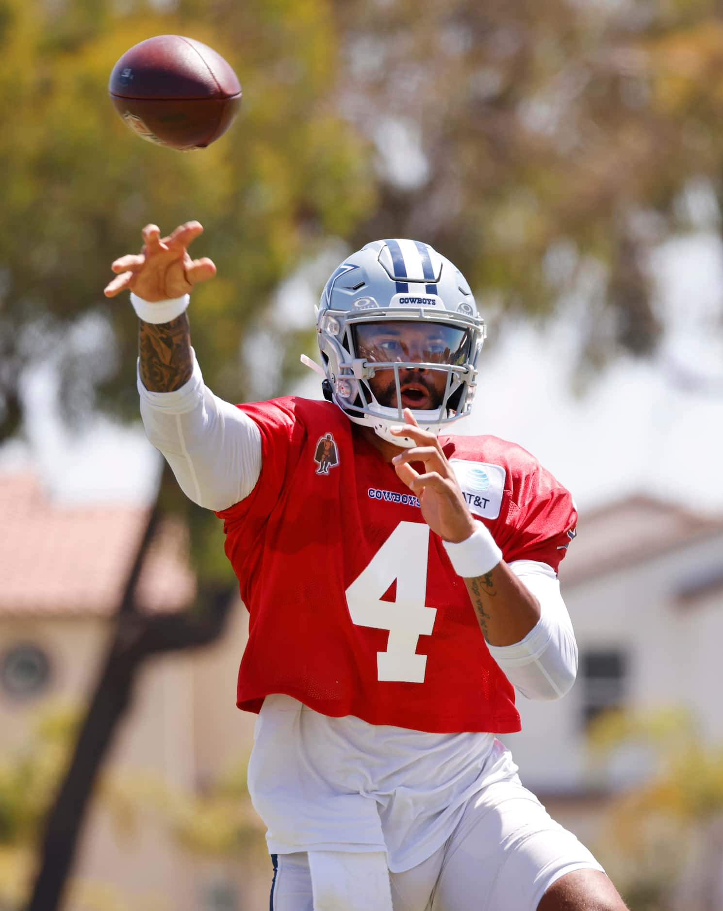 Dallas Cowboys quarterback Dak Prescott (4) throws to a target as he rolls out during...