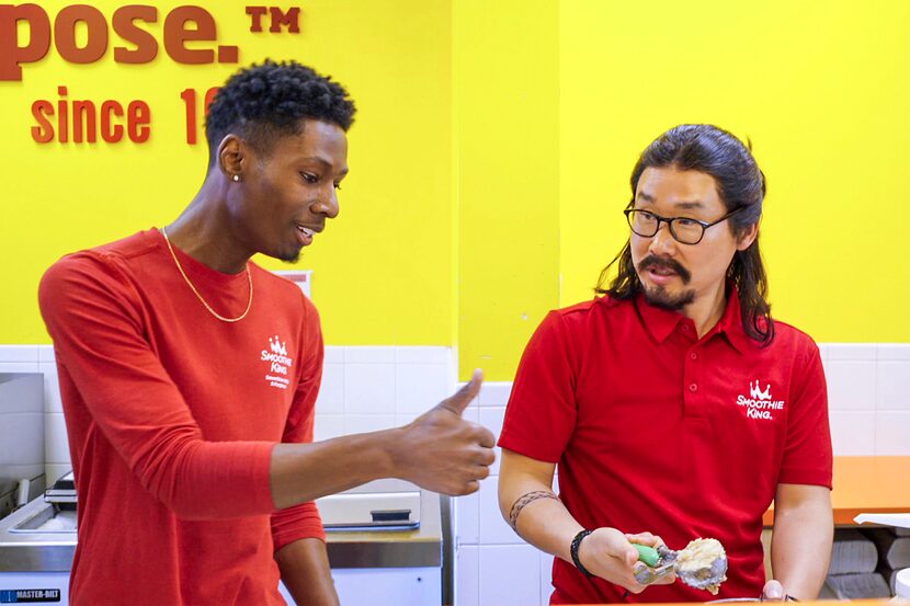 The CEO of Smoothie King, on right, wore a costume, wig and goatee for the filming of...