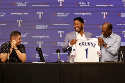 The Texas Rangers' Elvis Andrus (center) held his jersey with Los Angeles Angels manager Ron...