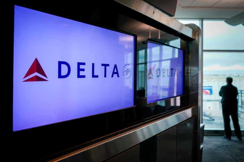 A man looks out from a Delta Airlines gate at Houston Hobby Airport on Friday, March 20,...