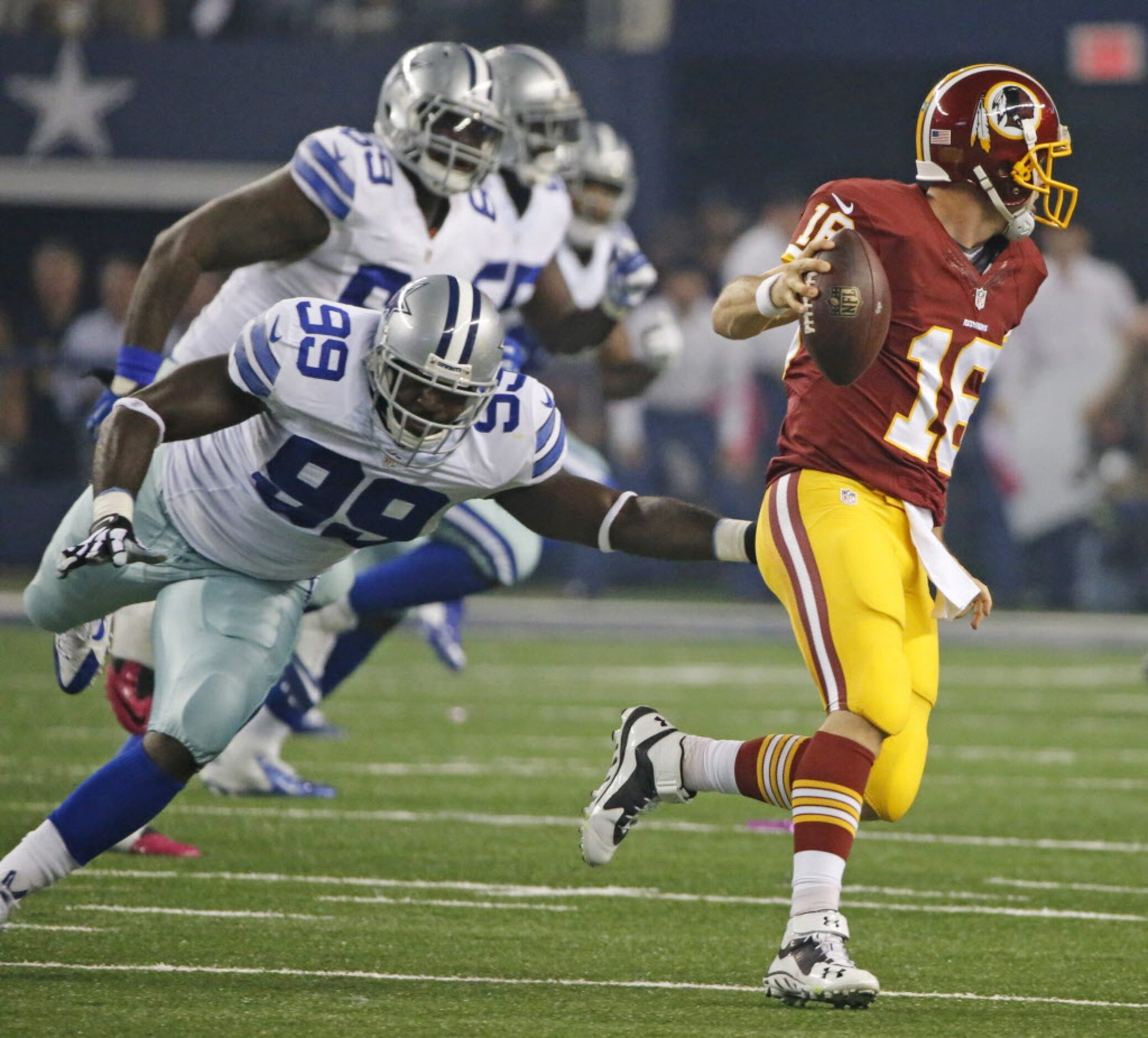 Washington Redskins quarterback Colt McCoy (16) scrambles away from Dallas Cowboys defensive...