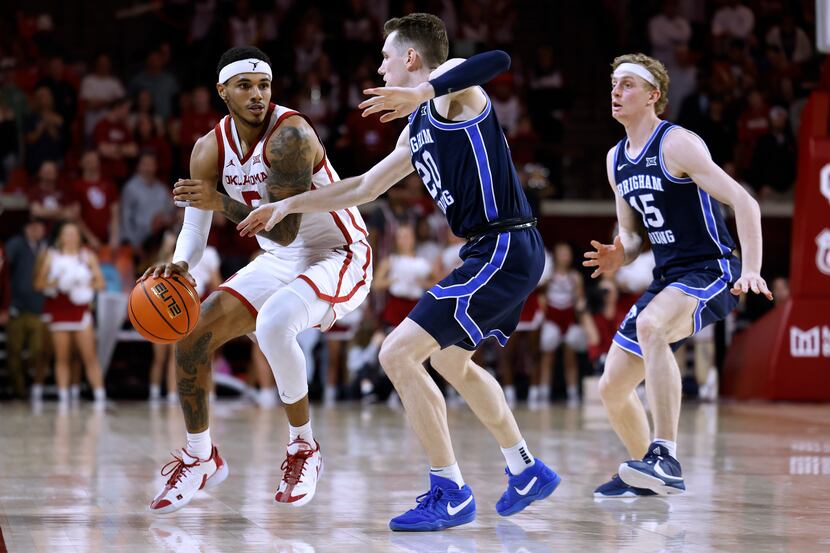 Oklahoma guard Rivaldo Soares is defended by BYU guard Spencer Johnson (20) and guard Richie...