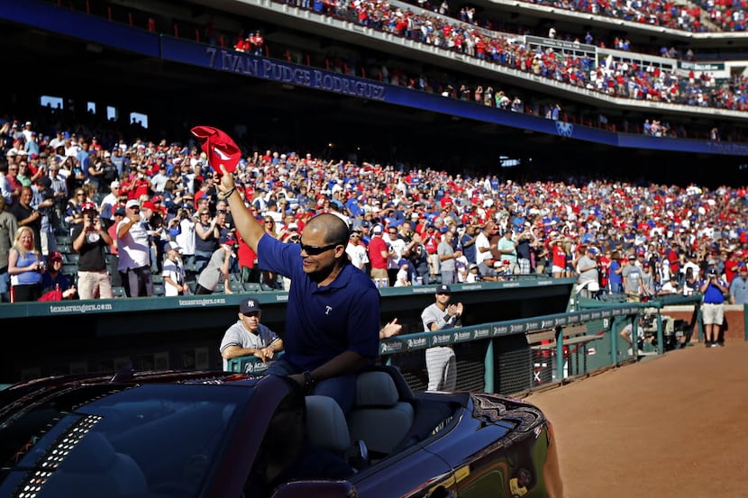 FILE - Former Texas Rangers catcher Ivan Rodriguez waves to the crowd during his retirement...