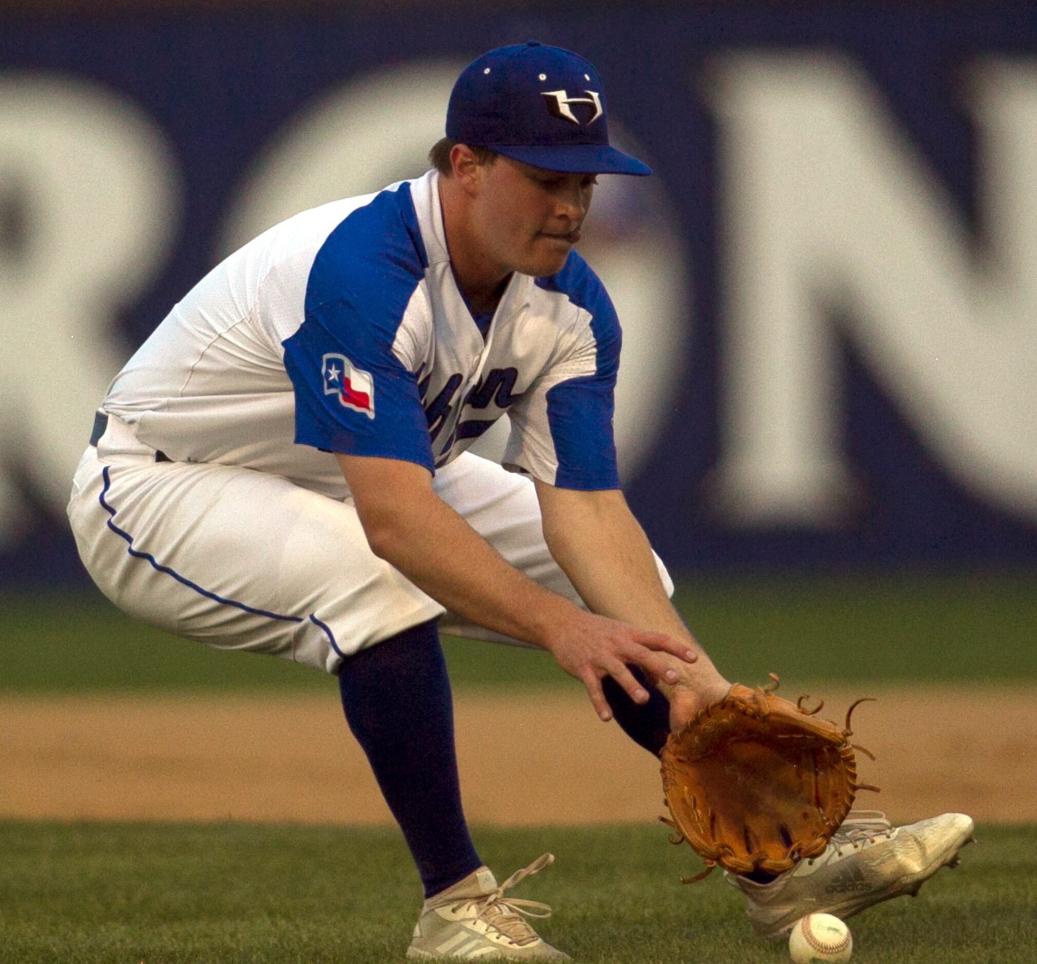 Hebron pitcher Jeremy Slate (2) charges from the mound to field a bunt from a Coppell batter...