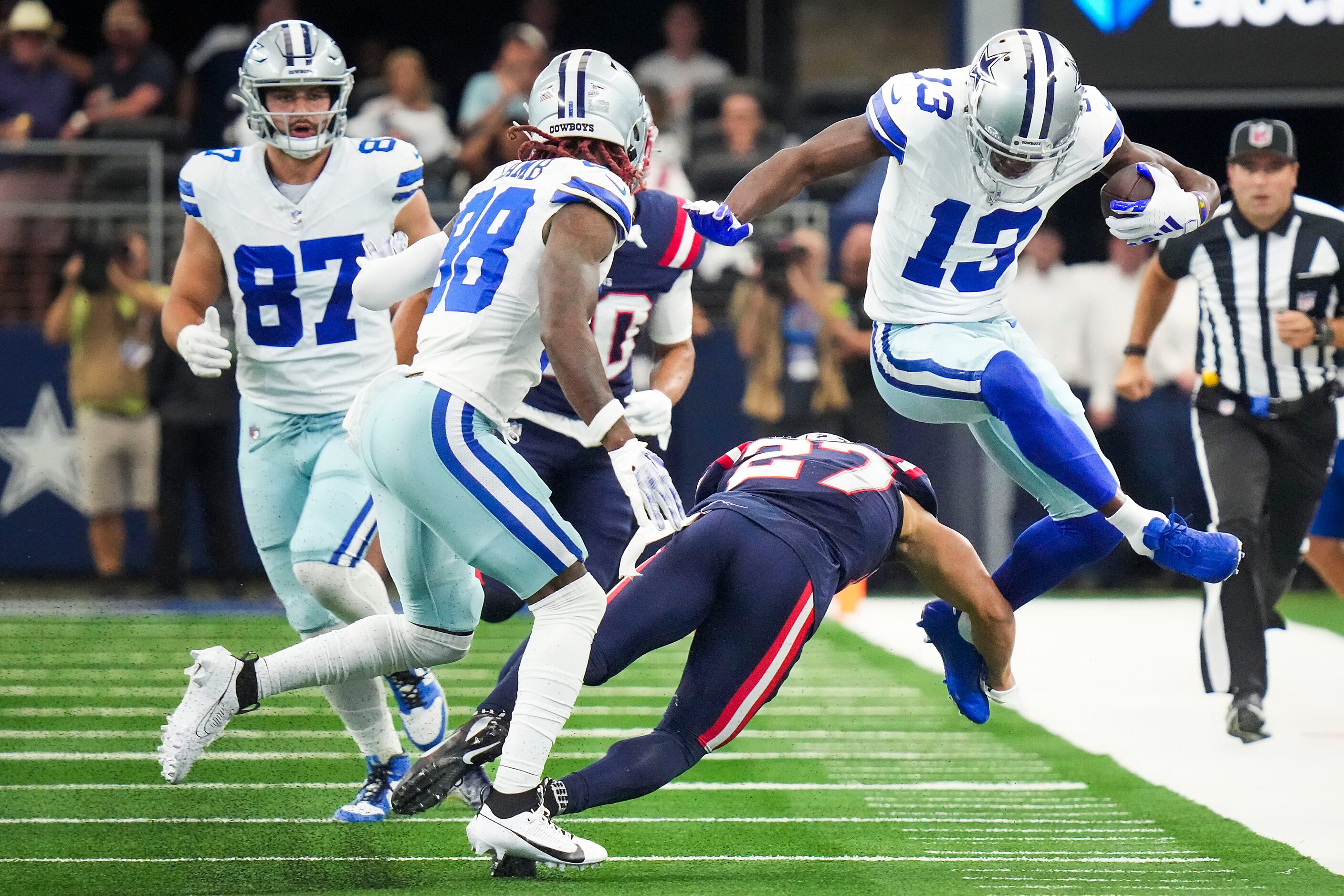 Dallas Cowboys wide receiver Michael Gallup (13) tries to hurdle New England Patriots...