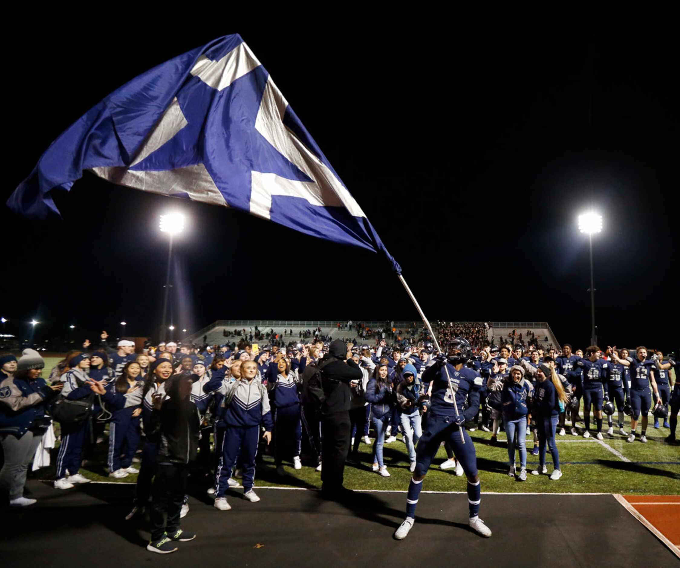 Frisco Lone Star senior defensive back Tyron Hall (8) waves the school flag after their...