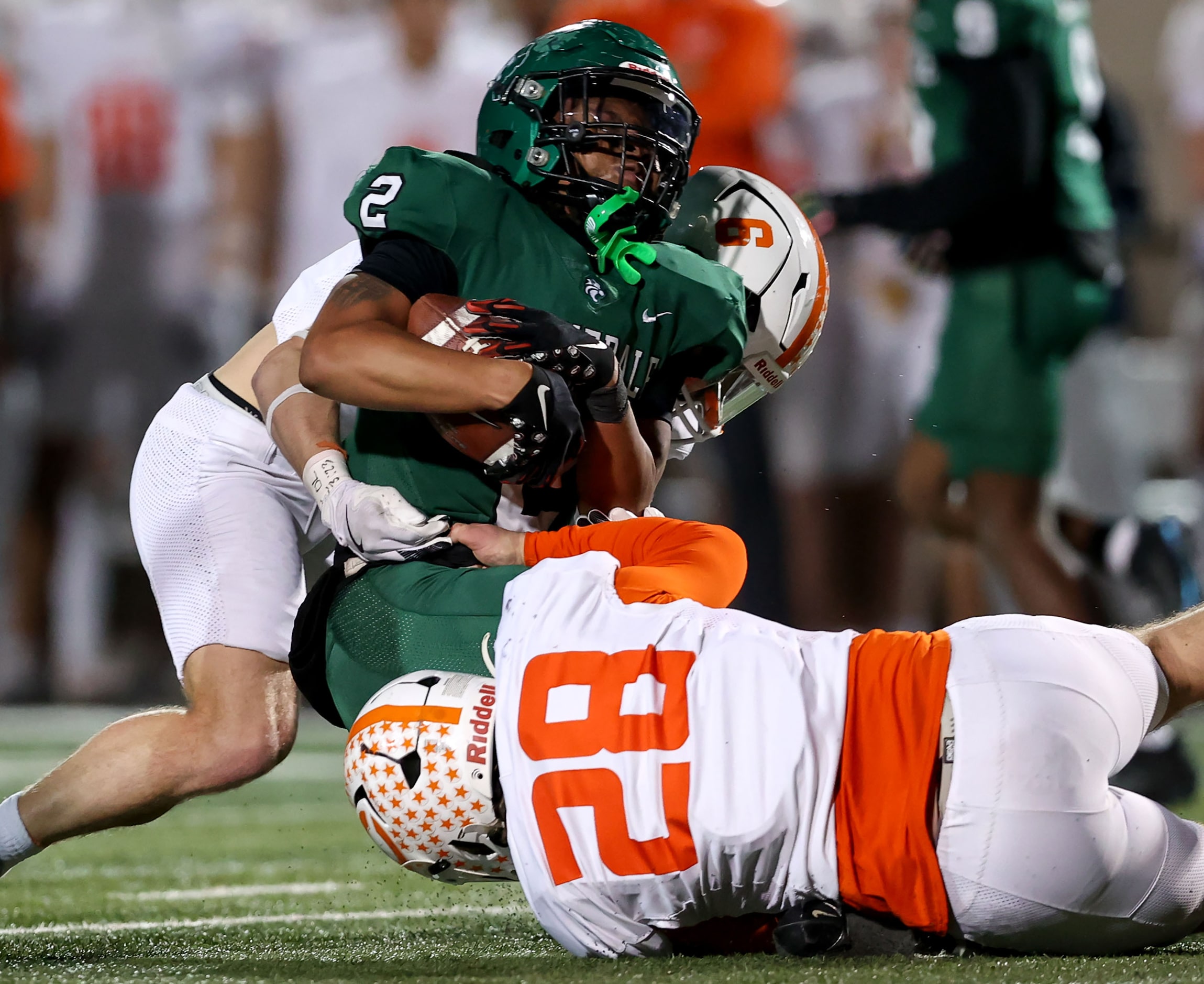 Kennedale running back Jordan Woodard (2) is stopped for a loss by Celina linebacker Cooper...