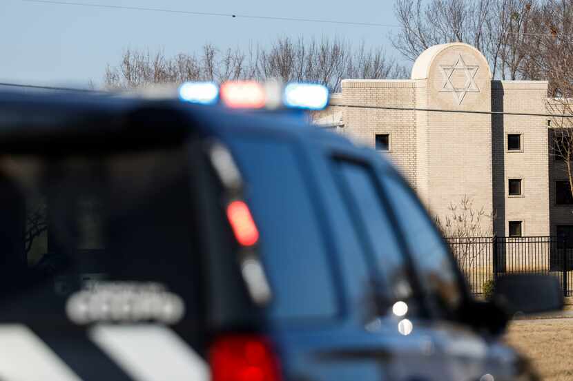 The Congregation Beth Israel synagogue is seen past a Colleyville police car on the day...