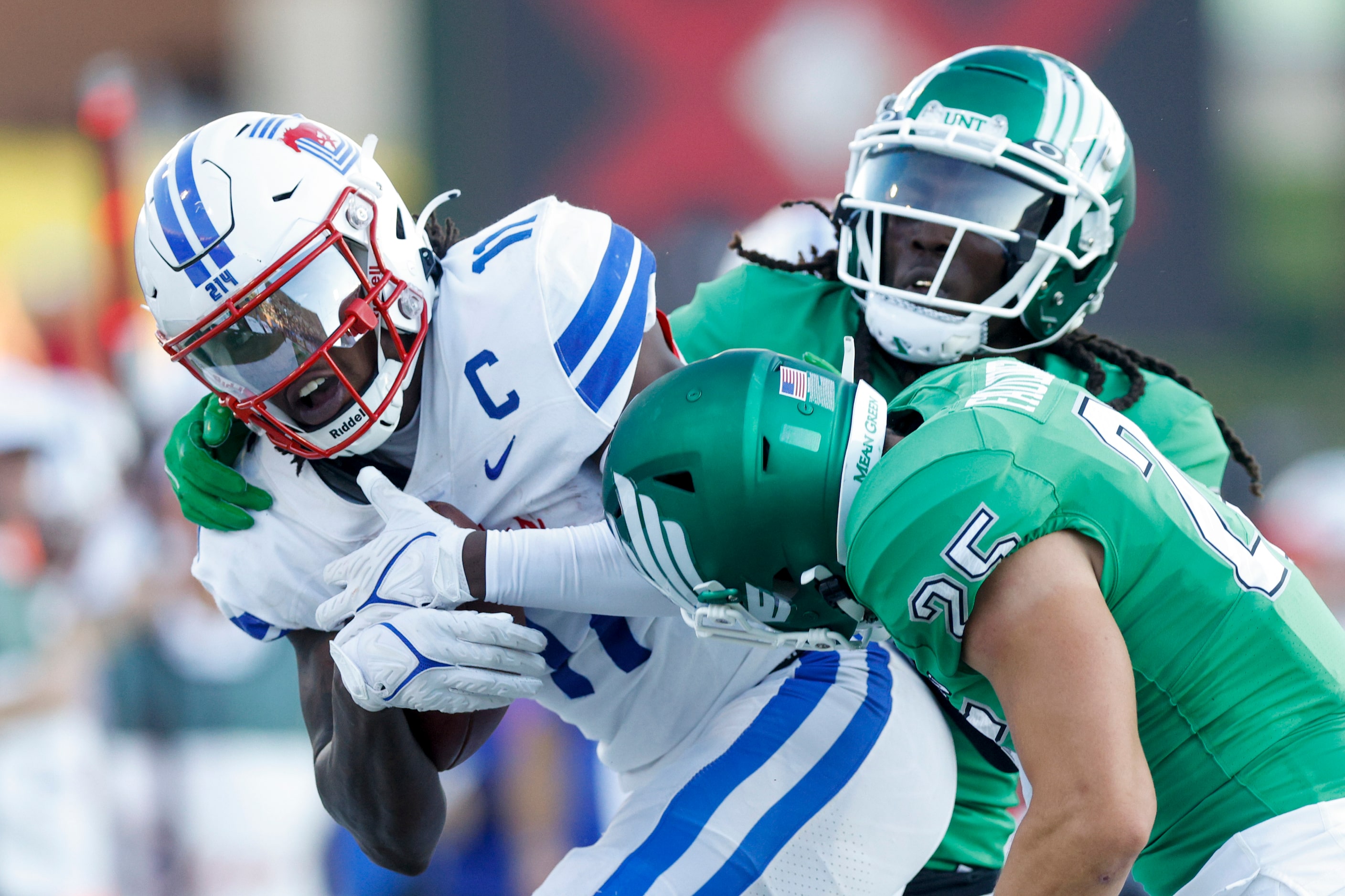 SMU wide receiver Rashee Rice (11) is forced out of bounds by UNT linebacker Sean-Thomas...