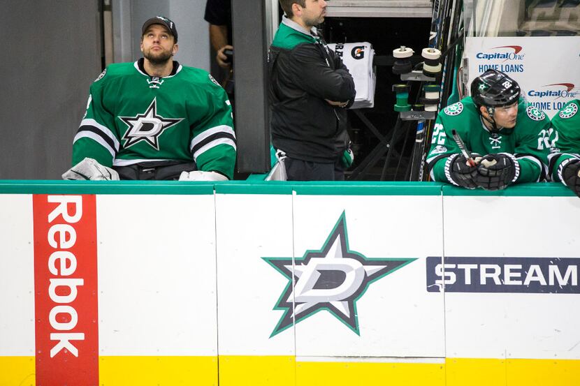 Dallas Stars goalie Antti Niemi watches from the bench during the third period of an NHL...