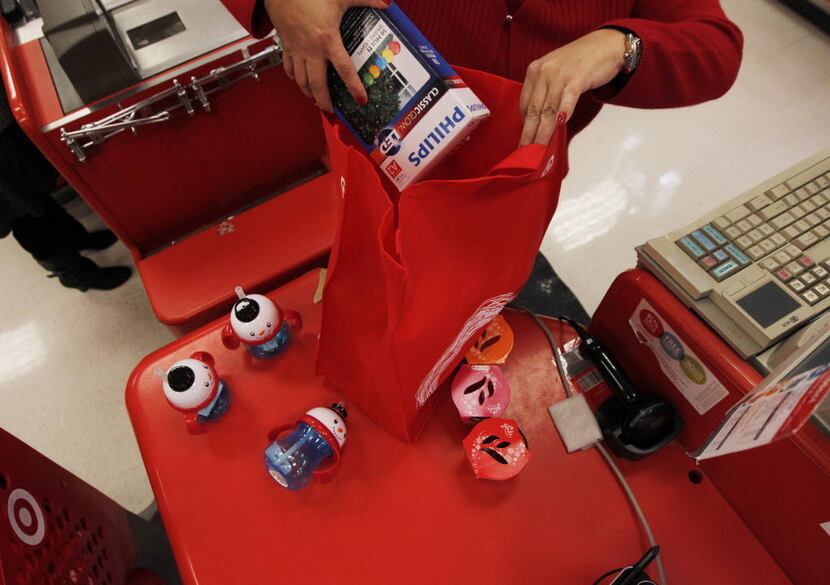 A checker at the Cityplace Target in Dallas loads a customer's purchases into a reusable bag.