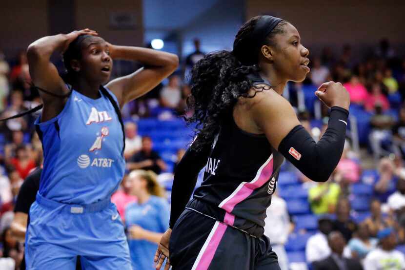 Dallas Wings guard Arike Ogunbowale (24, right) reacts after scoring and being fouled...