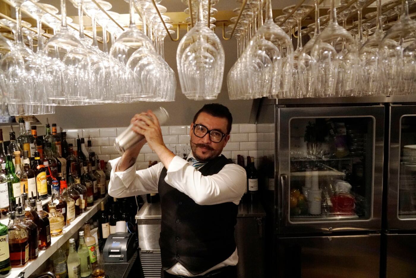 Bartender Israel Medellin prepares a drink at the new Al Biernat's restaurant in north...