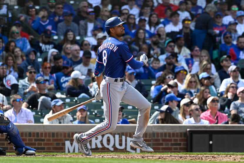 Texas Rangers' Bubba Thompson, hits an RBI triple against the Chicago Cubs during the sixth...