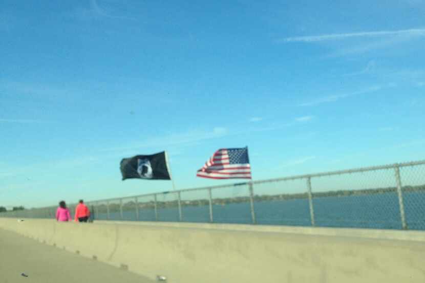 A two-flag Veterans Day display over Lake Ray Hubbard flies in the face of Texas Department...