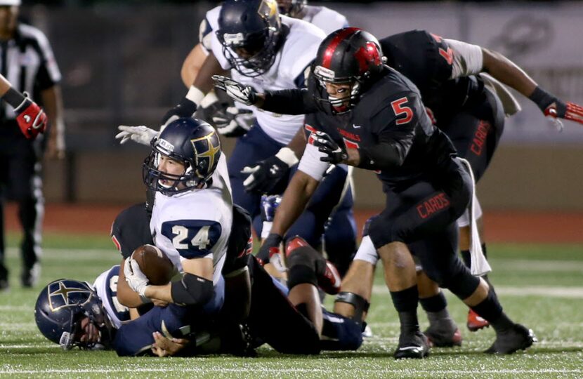 Irving MacArthur’s Darius Kirksey (5) pressures Jesuit’s Adam Holtz (24) during game action,...