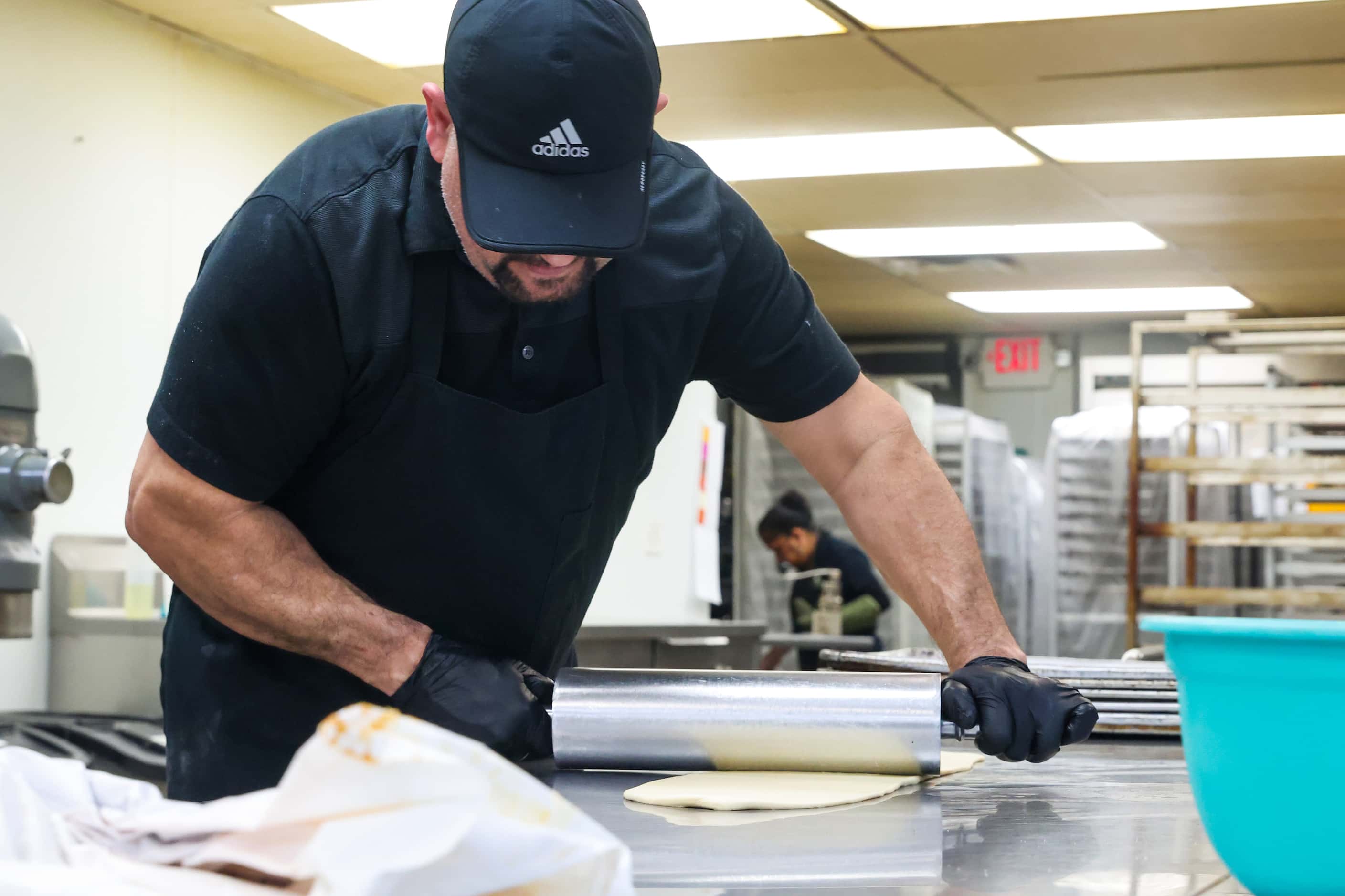 Baker Isaac Ramirez rolls the dough for Rosca de Reyes at Tango Bakery in Garland on...