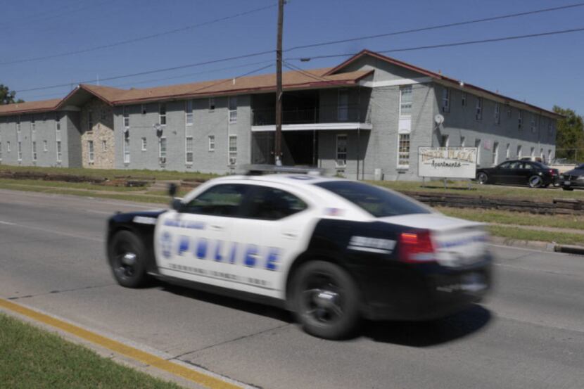 A Dallas police cruiser passes the Delta Plaza Apartments, nicknamed "New Jack City" because...