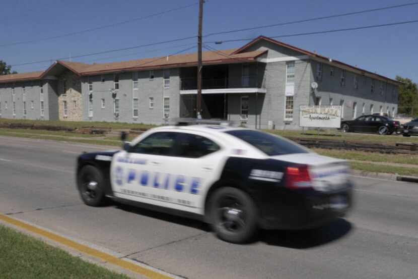 A Dallas police cruiser passes the Delta Plaza Apartments, nicknamed "New Jack City" because...