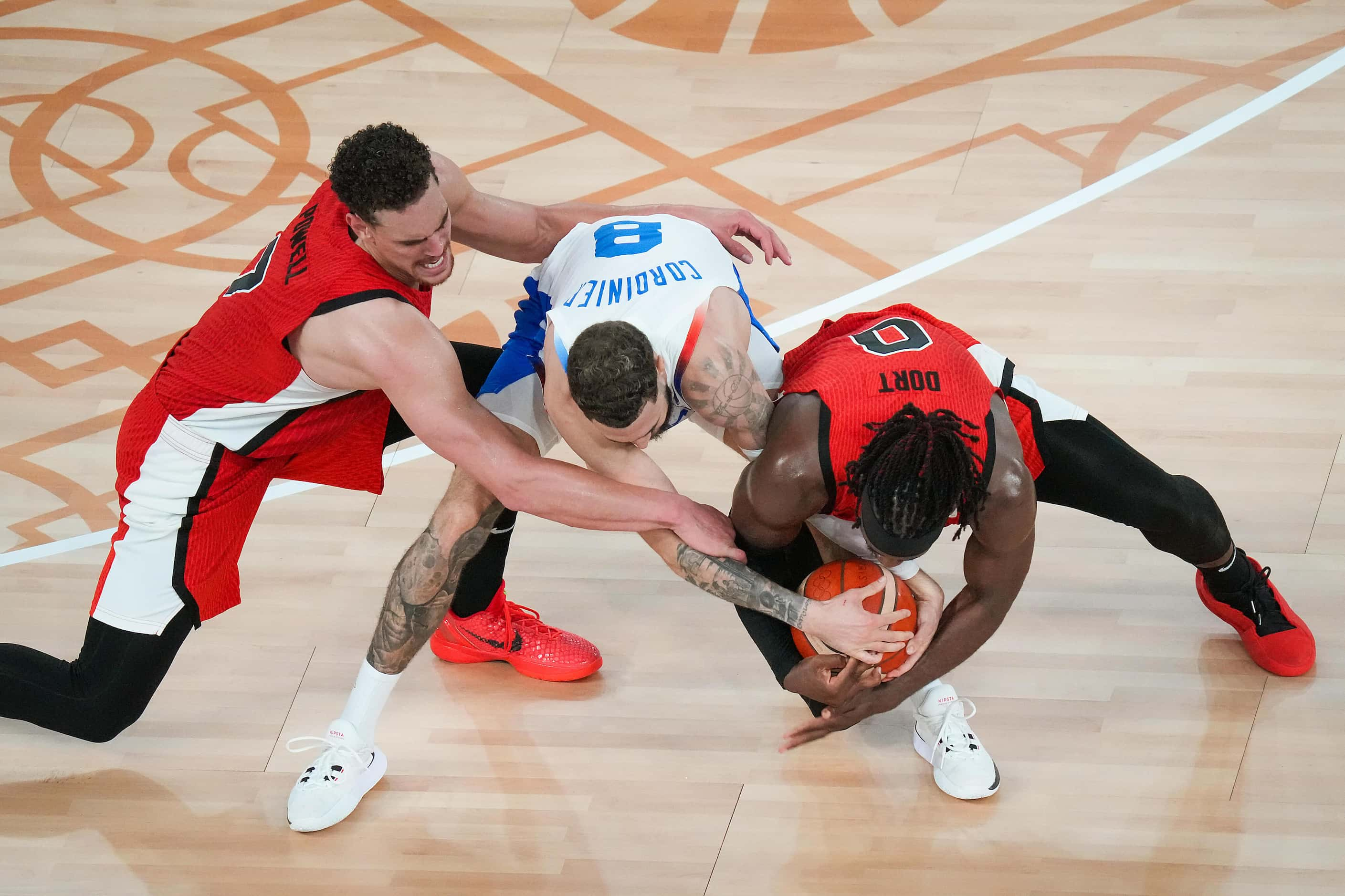 Luguentz Dort (0) of Canada and Dwight Powell (7) try to wrestle the ball away from Isaia...