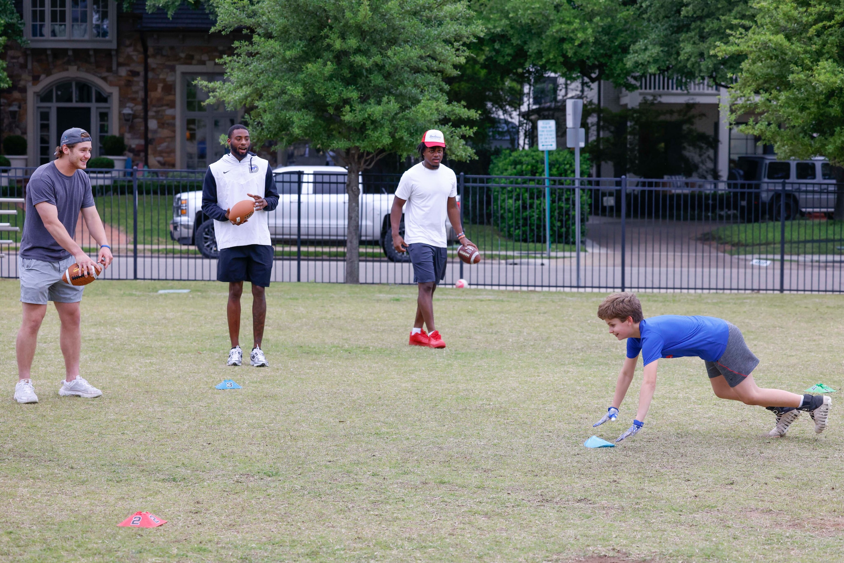 SMU QB Preston Stone (left) instructs Grant Sacher (right) during a special session of...