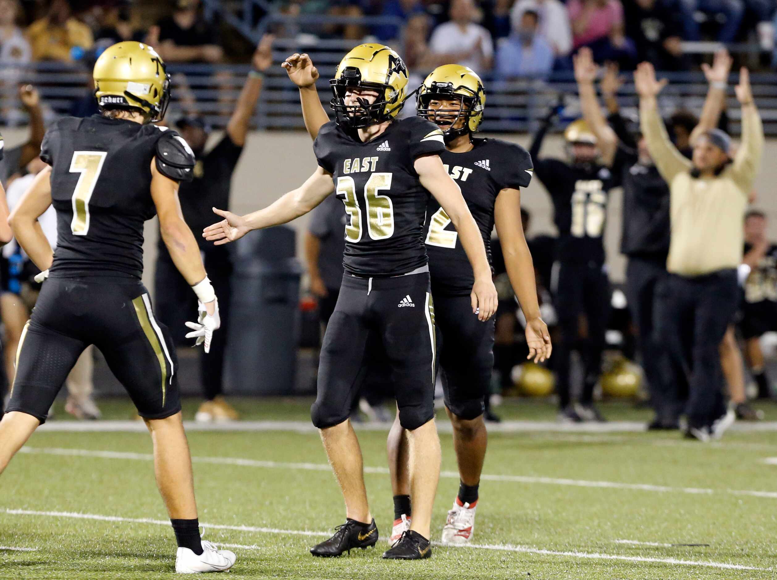 Plano East kicker Buss Flabiano (36) is congratulated by teammates after kicking a...