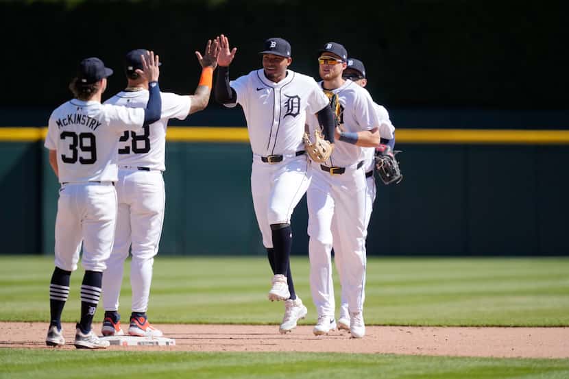 Detroit Tigers right fielder Wenceel Perez high fives shortstop Javier Baez after the ninth...