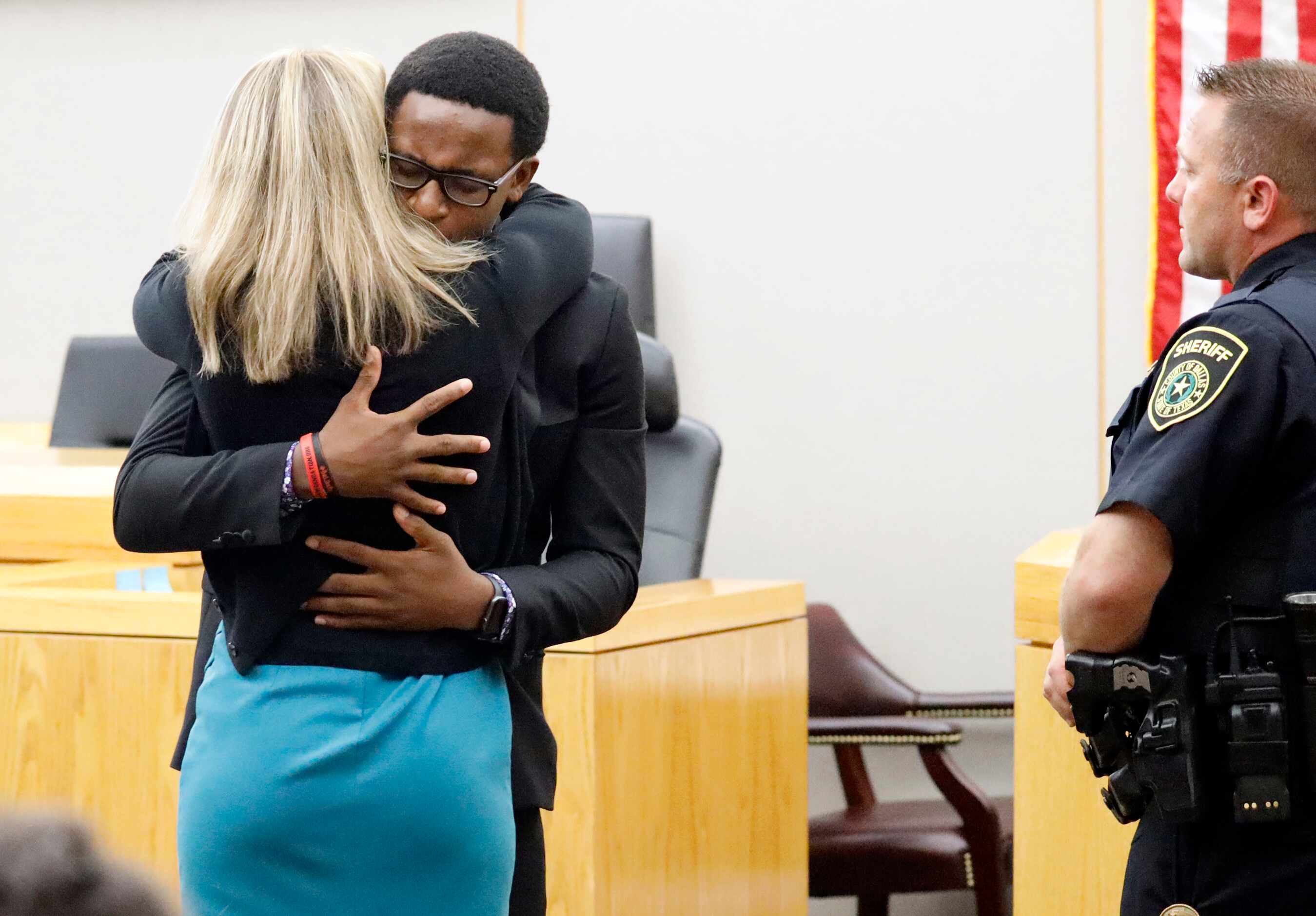 Brandt Jean hugs Guyger after delivering his impact statement in the courtroom after the...