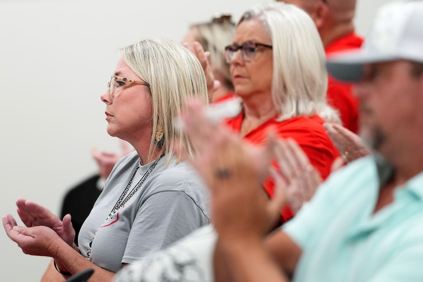 Lorena Primary School Principal April Jewell applauds a speaker during the public comment...