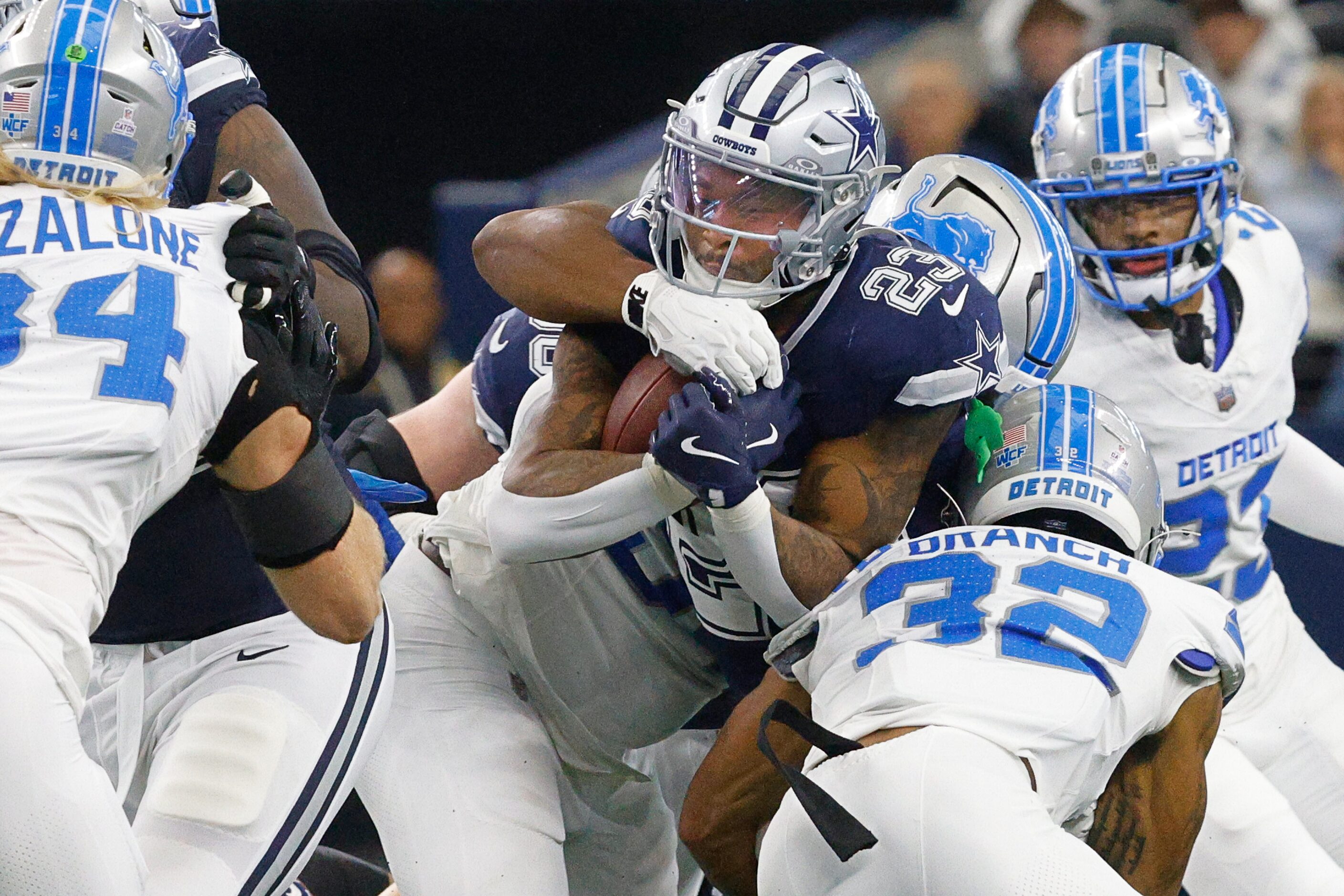 Dallas Cowboys running back Rico Dowdle (23) tries to keep the ball against Detroit Lions...