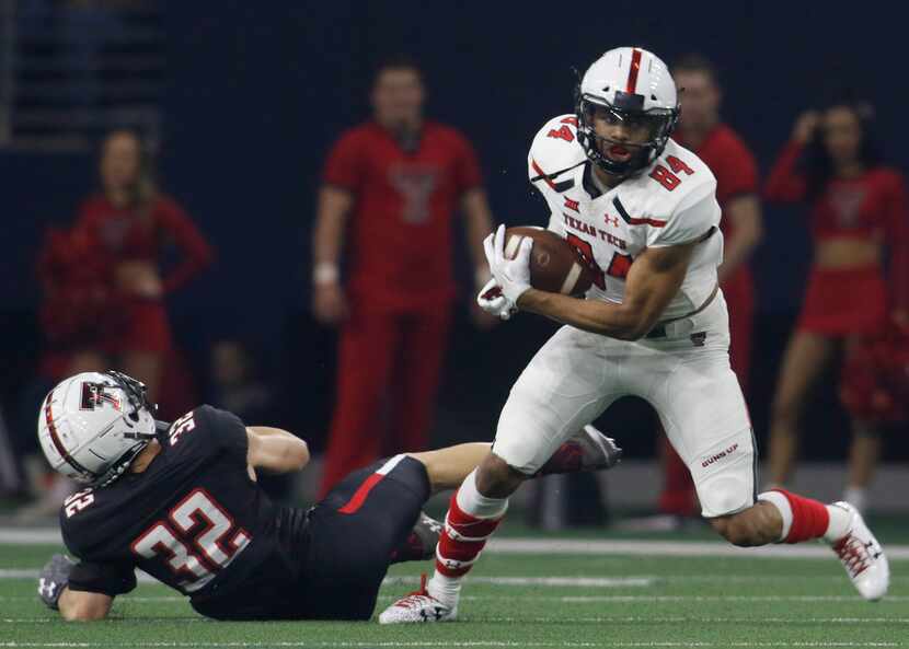 Texas Tech receiver Erik Ezukanma (84) pulls in a pass and is able to elude the defensive...