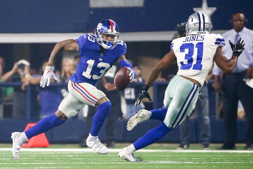 New York Giants wide receiver Odell Beckham (13) carries the ball as he is defended by New...