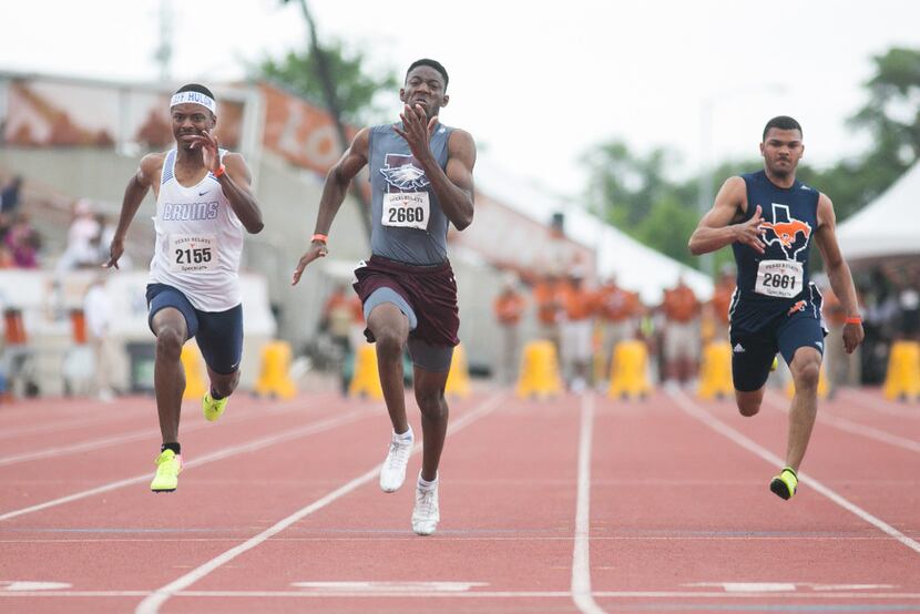 Garland Rowlett's Joseph Sheffield, center, takes first in the boys 100 meter dash with a...