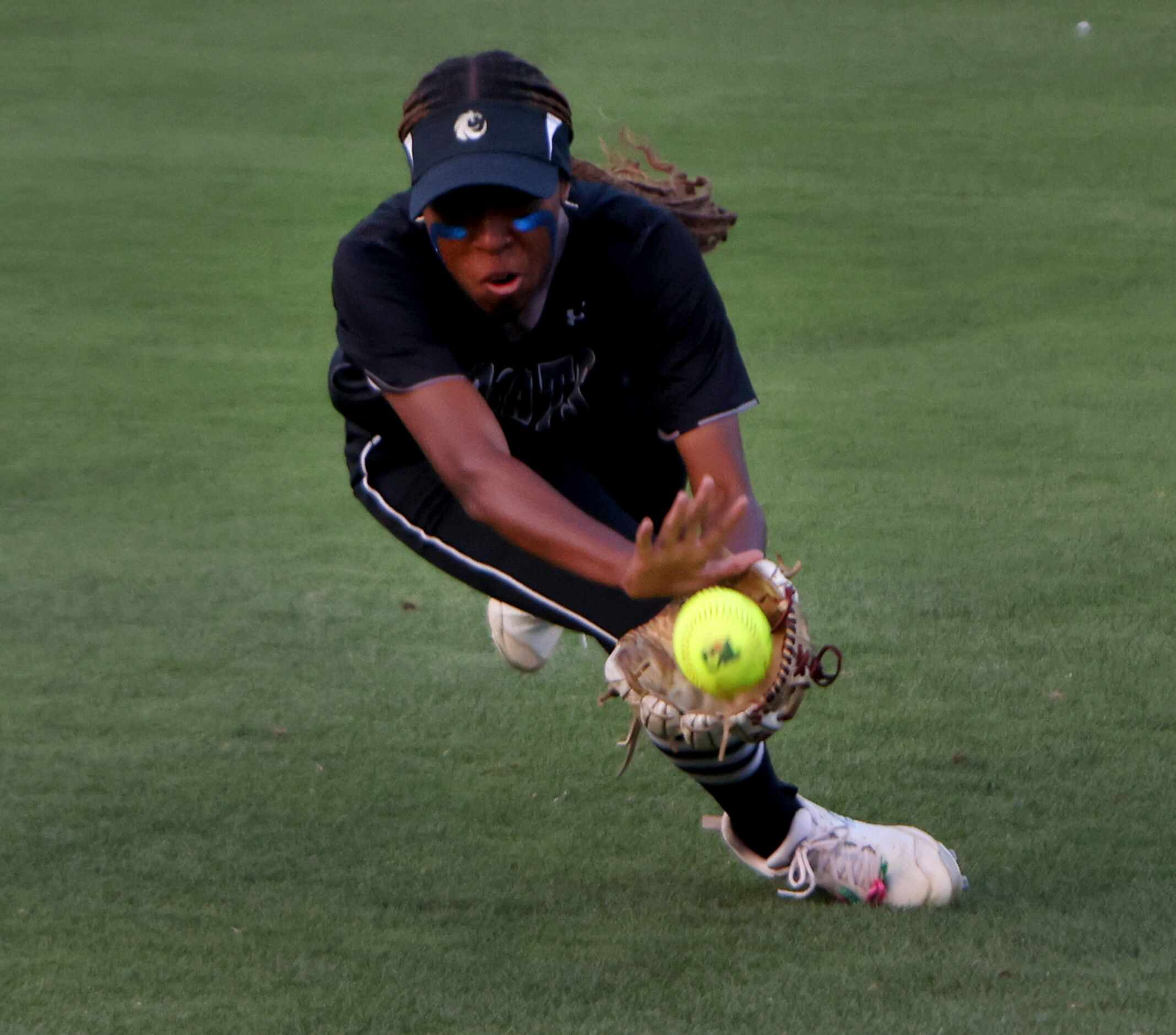 Denton Guyer right fielder Lauryn Jones (3) shows great concentration as she lunges for a...