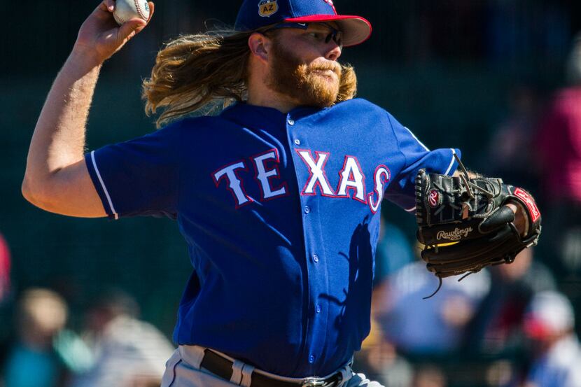 Texas Rangers starting pitcher A.J. Griffin (64) pitches during the fifth inning of a spring...