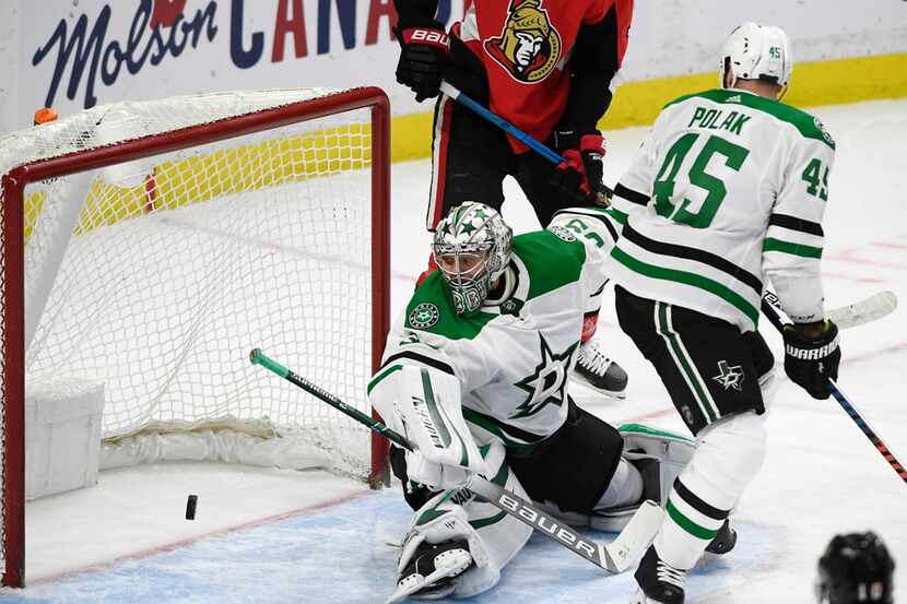 Dallas Stars goaltender Anton Khudobin (35) watches a shot by Ottawa Senators centre...