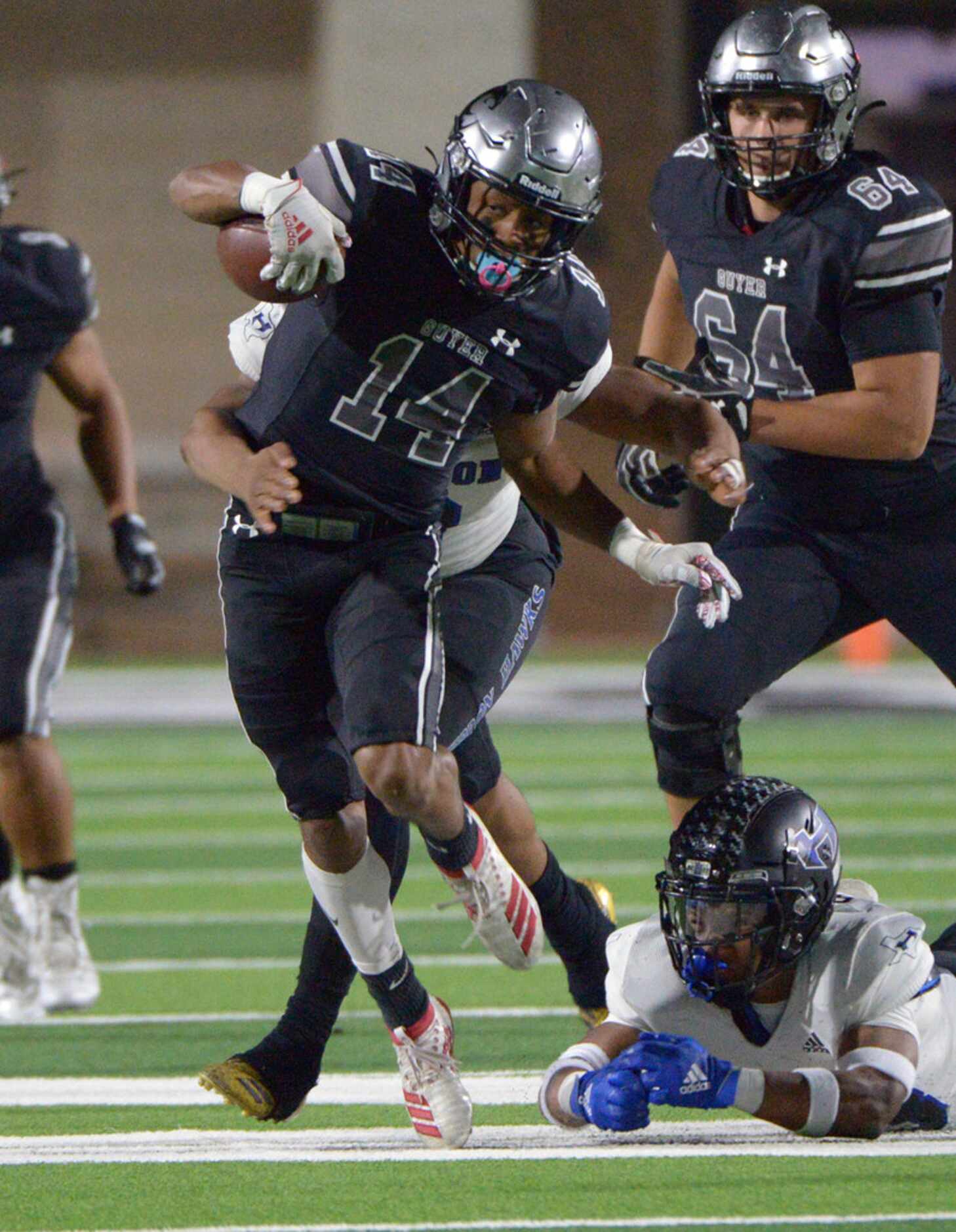 Guyer's Travis Romar (14) looks for running room in the second half of a Class 6A Division...