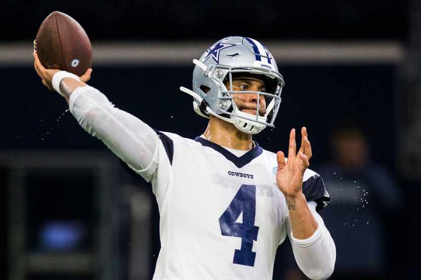 Dallas Cowboys quarterback Dak Prescott (4) throws a pass during a Dallas Cowboys OTA...