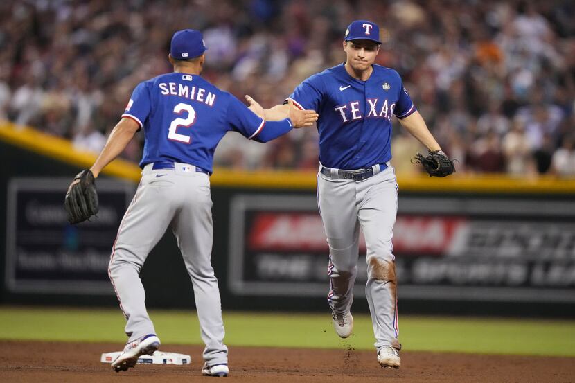 Texas Rangers second baseman Marcus Semien (right) celebrates with shortstop Corey Seager...