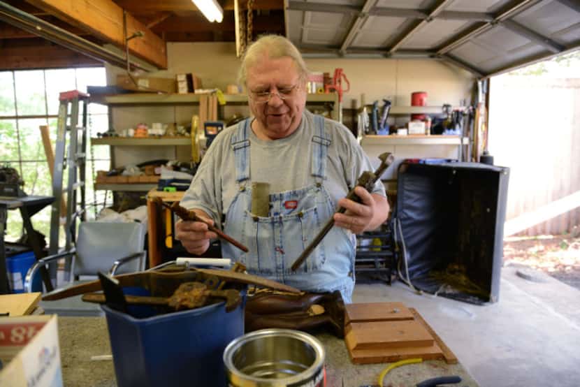 Joe Hardman goes through scraps that he will use to construct a new mailbox after the city...