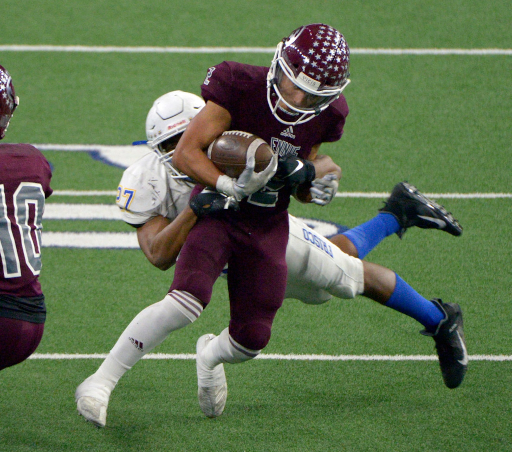 Ennis' Dyllan Santos (2) runs through a tackle attempt by Frisco's Aaron Taylor (27) in the...