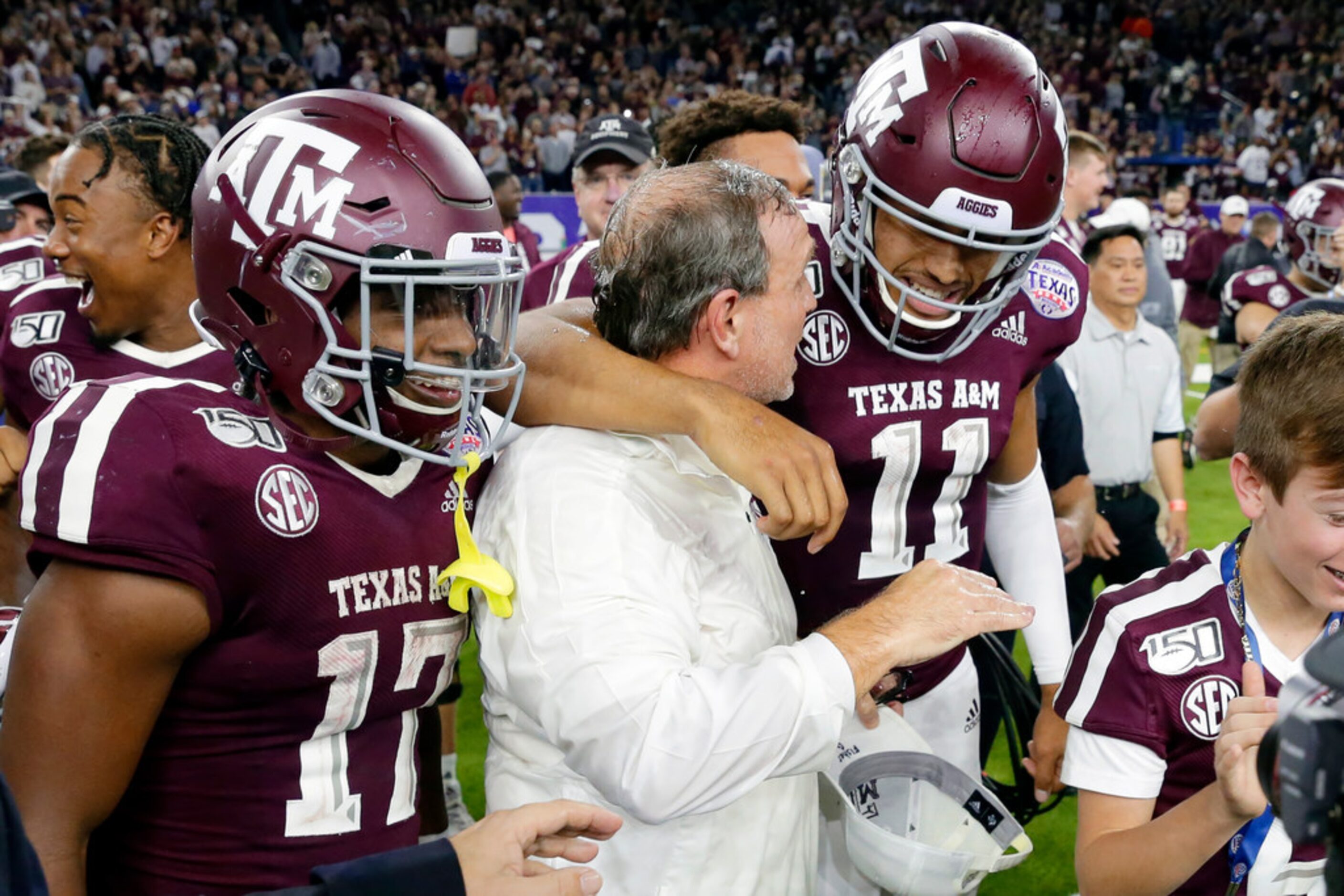 Texas A&M wide receiver Ainias Smith (17), coach Jimbo Fisher and quarterback Kellen Mond...