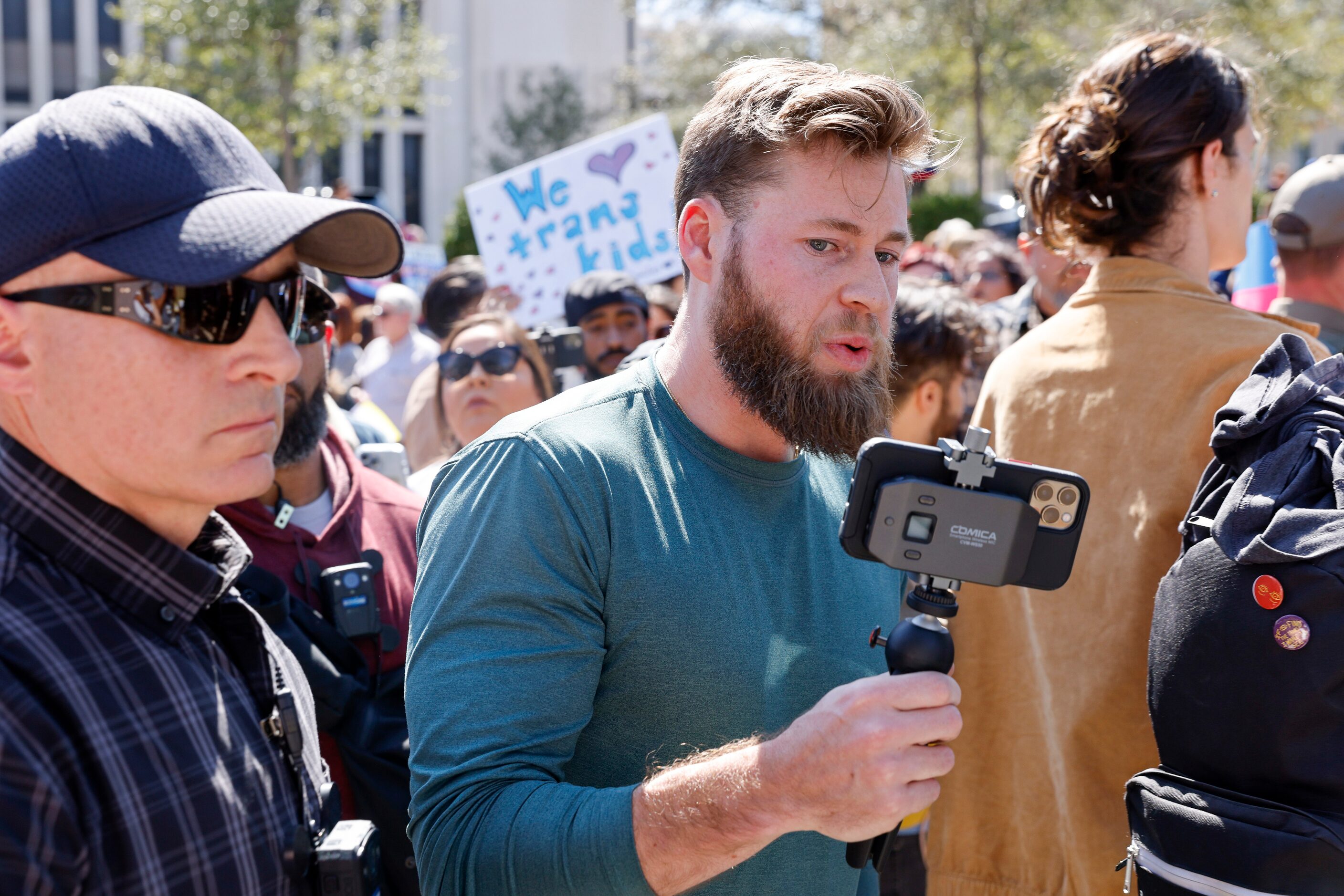 Infowars host Jonathon Owen Shroyer records a video as he tries to engage with attendees...