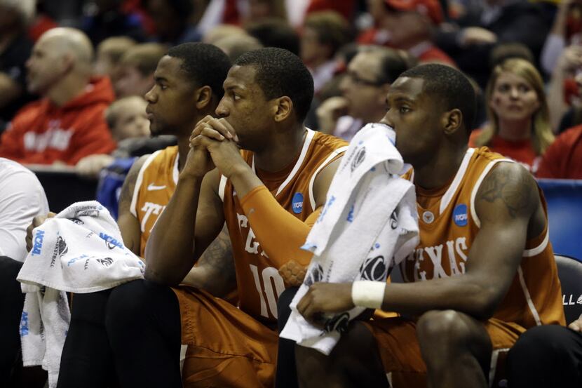 Texas' Prince Ibeh, left, Texas forward Jonathan Holmes and Kendal Yancy watch from the...