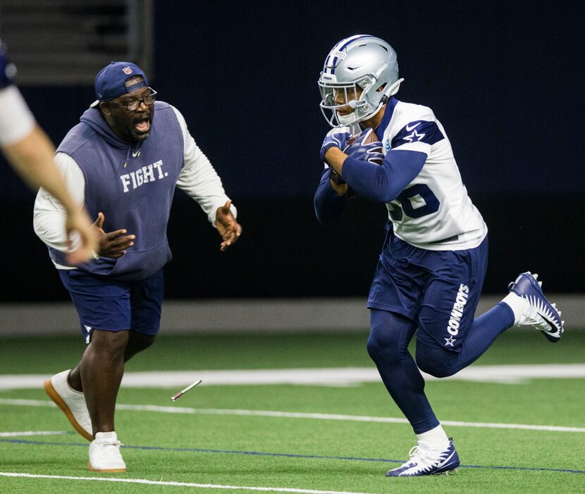 Dallas Cowboys running back Tony Pollard (36) gets some encouragement from running backs...