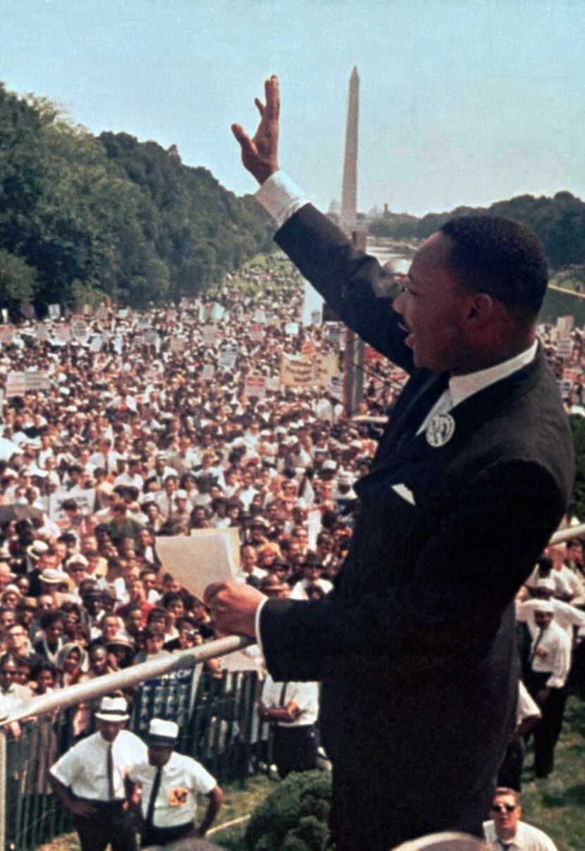 In this Aug. 28, 1963, file photo, the Rev. Martin Luther King Jr. waves to the crowd at the...