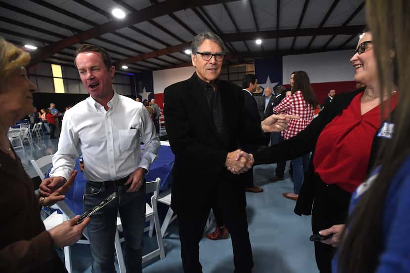 Former Gov. Rick Perry greets guests as he joins Texas House Speaker Dade Phelan for a...