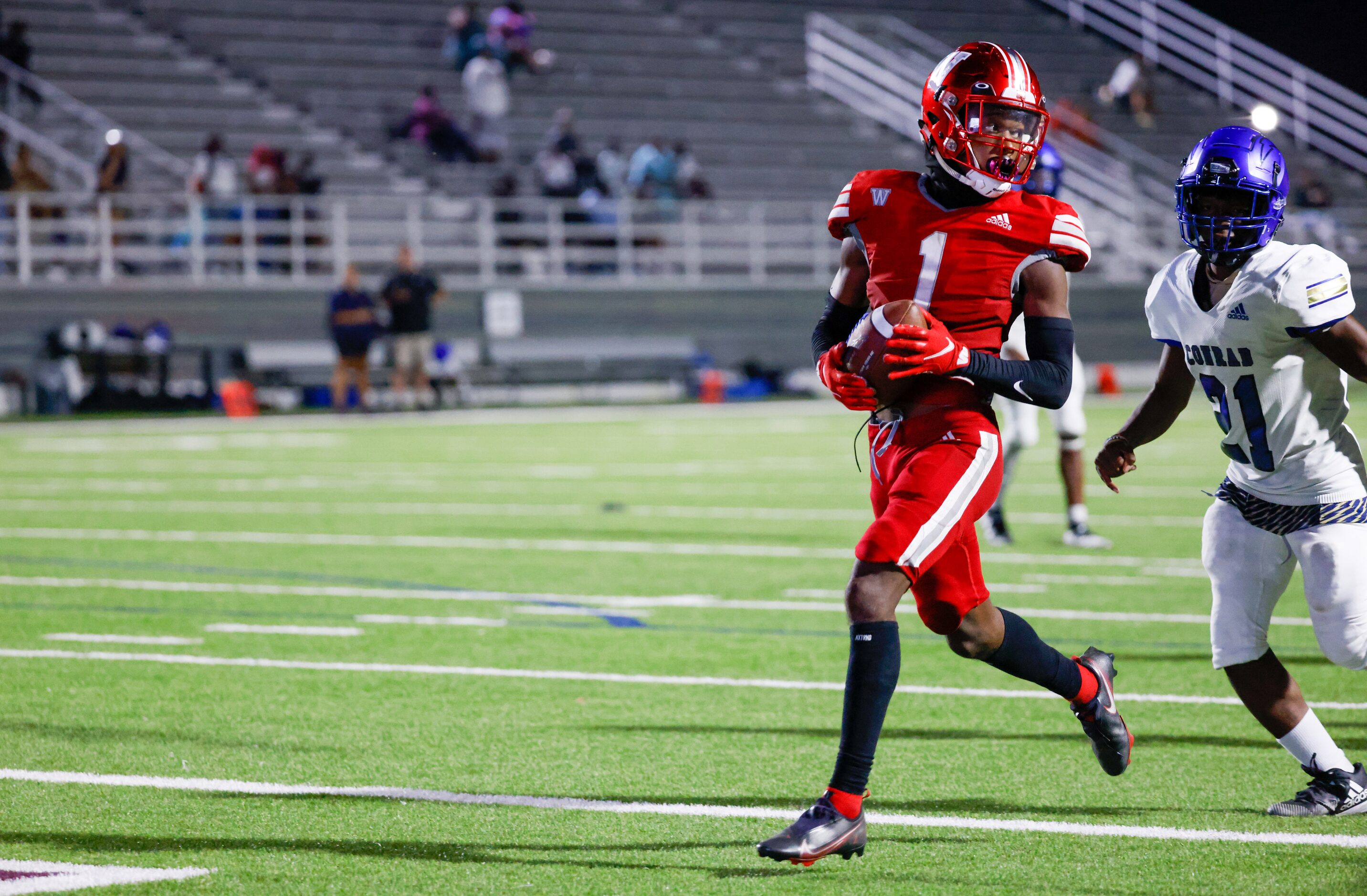 Woodrow Wilson wide receiver Cyris Taylor (1) looks behind him as he enters the end zone for...