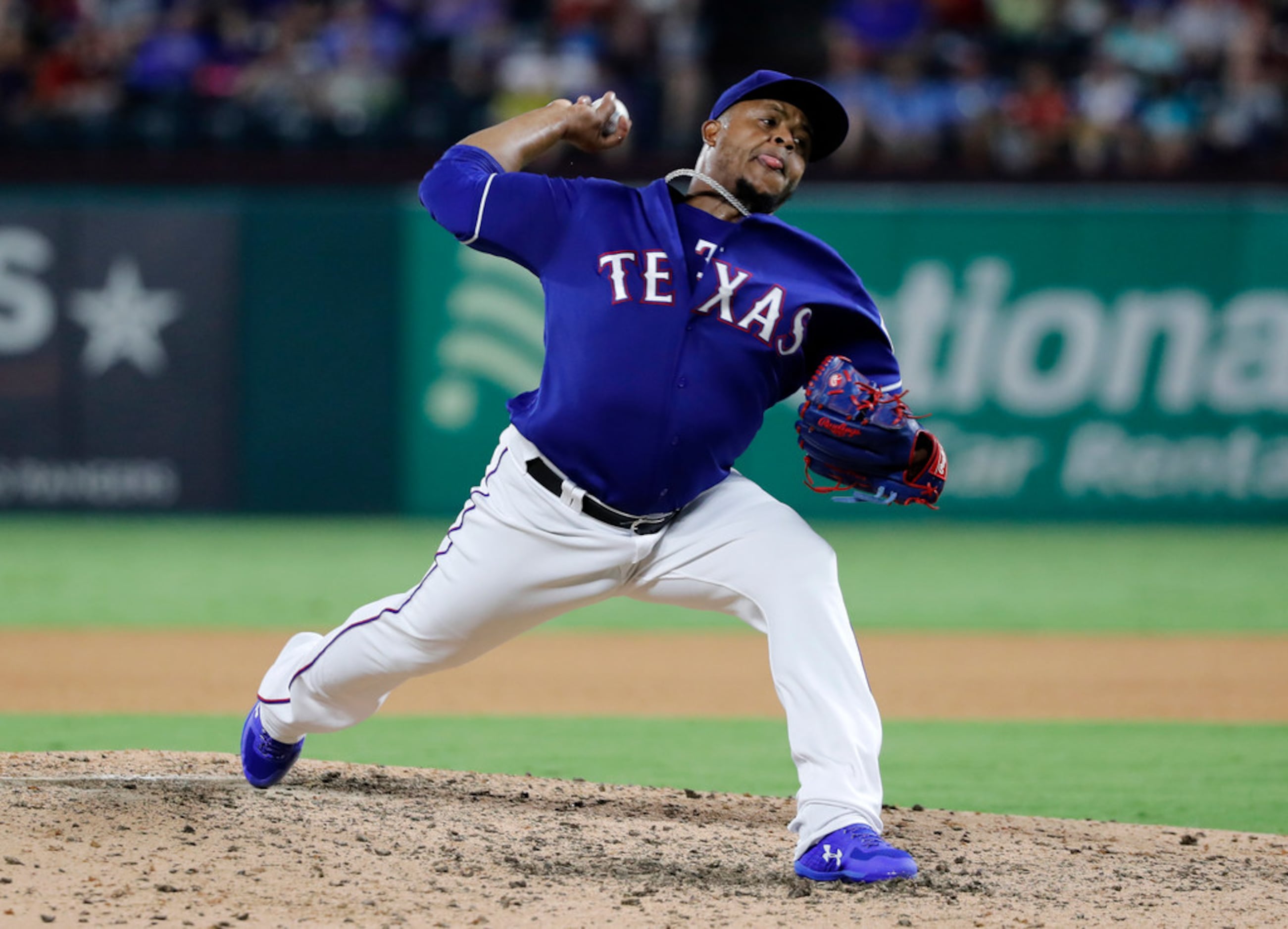 Texas Rangers starting pitcher Edinson Volquez throws to the Oakland Athletics in the...