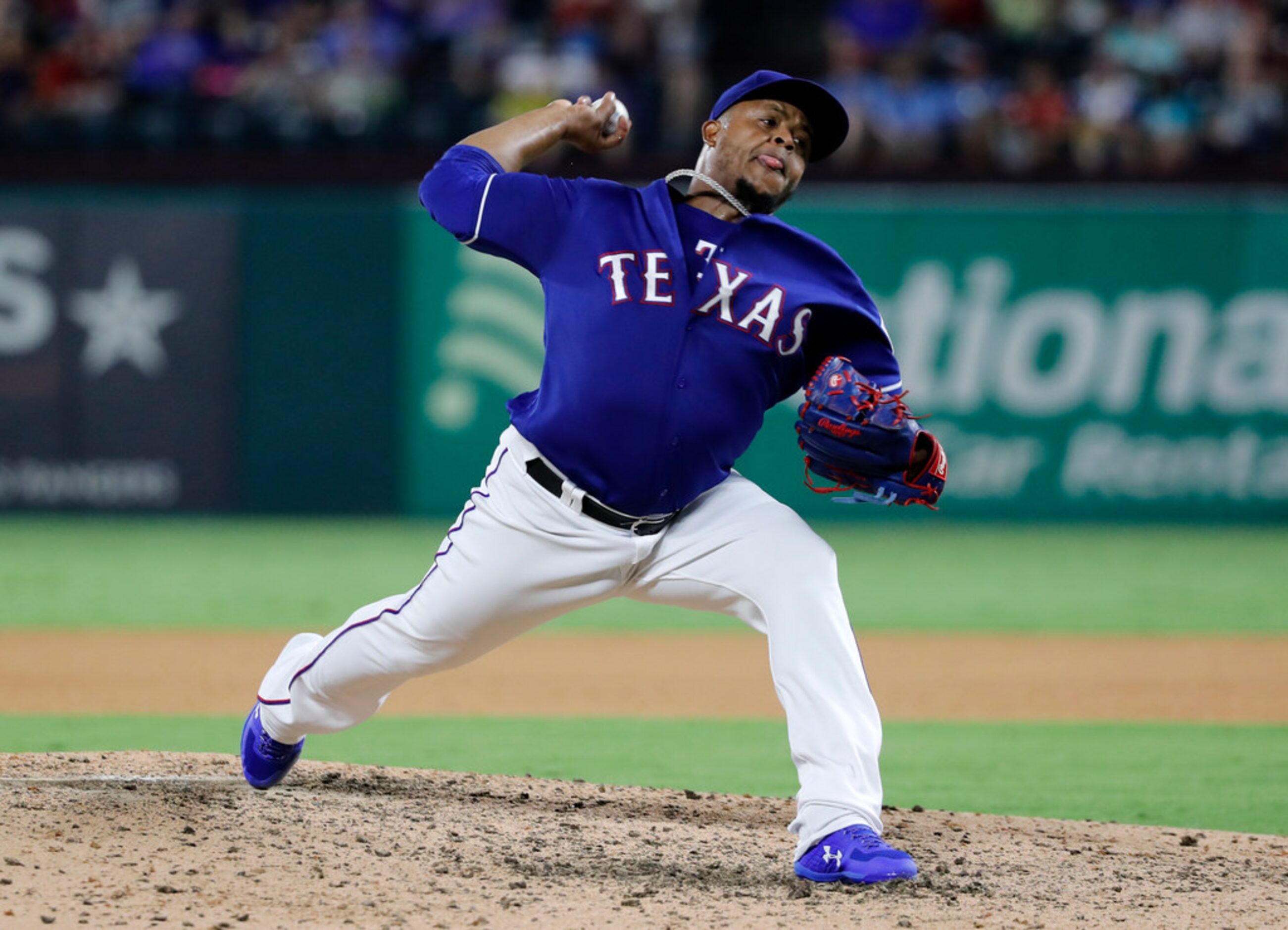 Texas Rangers starting pitcher Edinson Volquez throws to the Oakland Athletics in the...